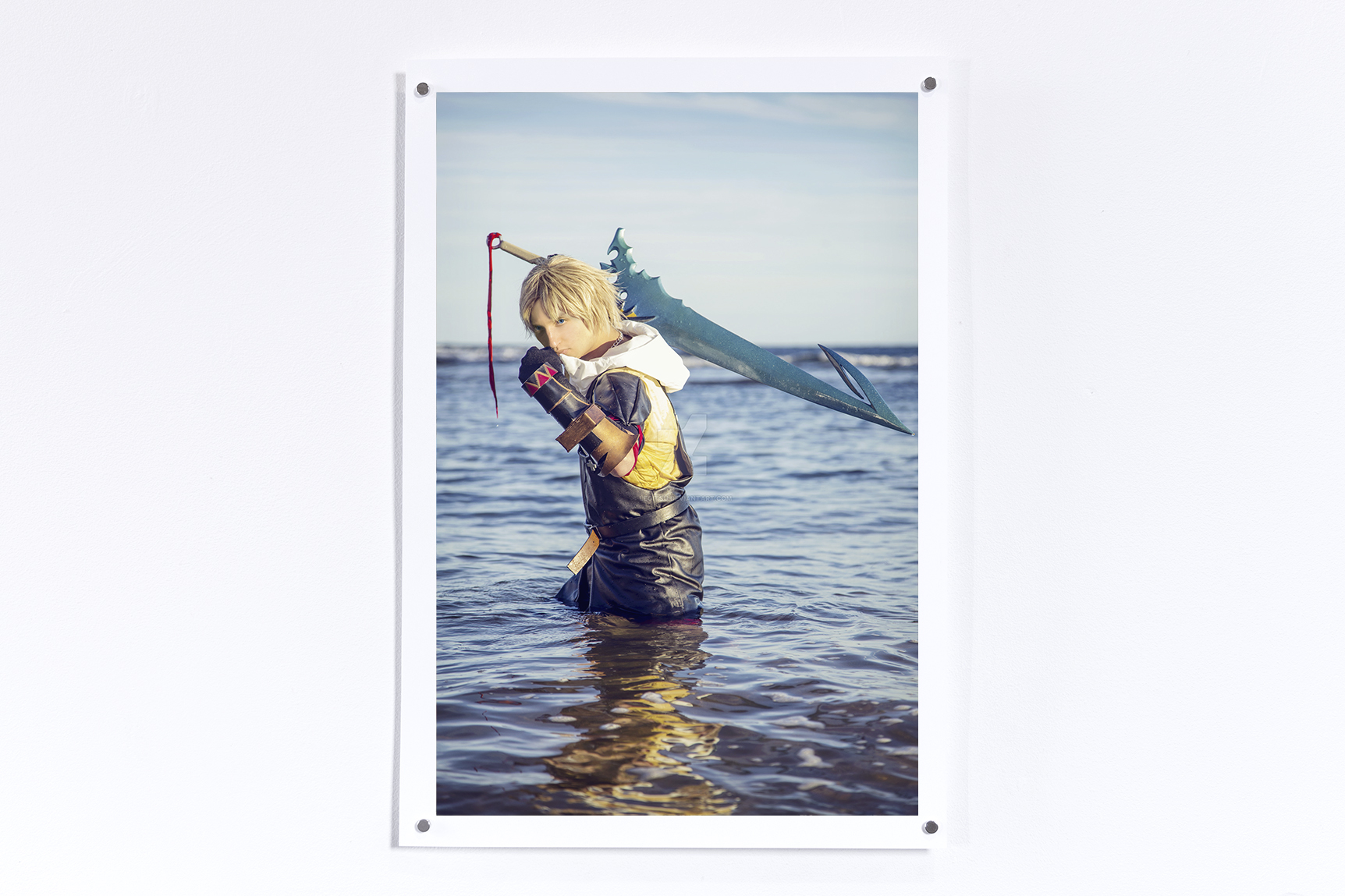 Print hung on a white wall of Tidus from Final Fantasy 10 in he ocean with Jesse's face superimposed on the character